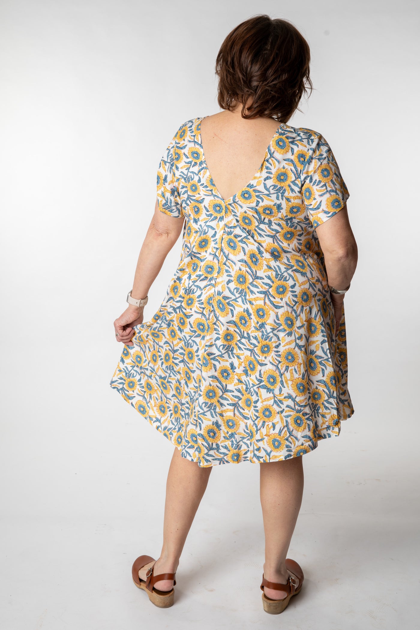 Betty is wearing a babydoll dress in sunflower