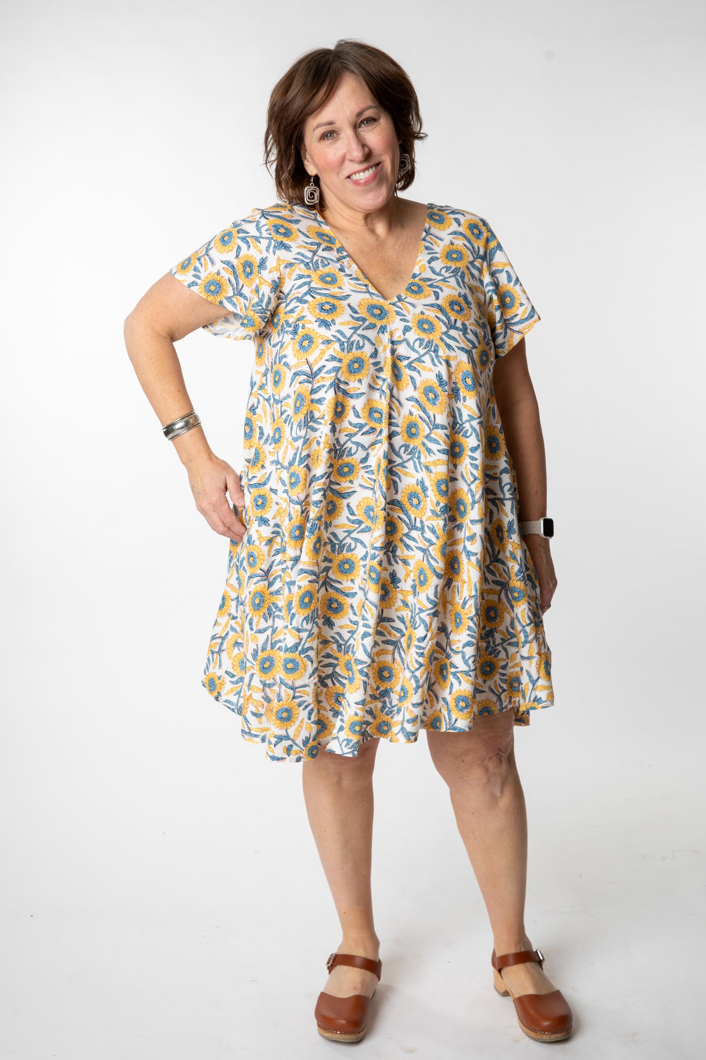 Betty is wearing a babydoll dress in sunflower