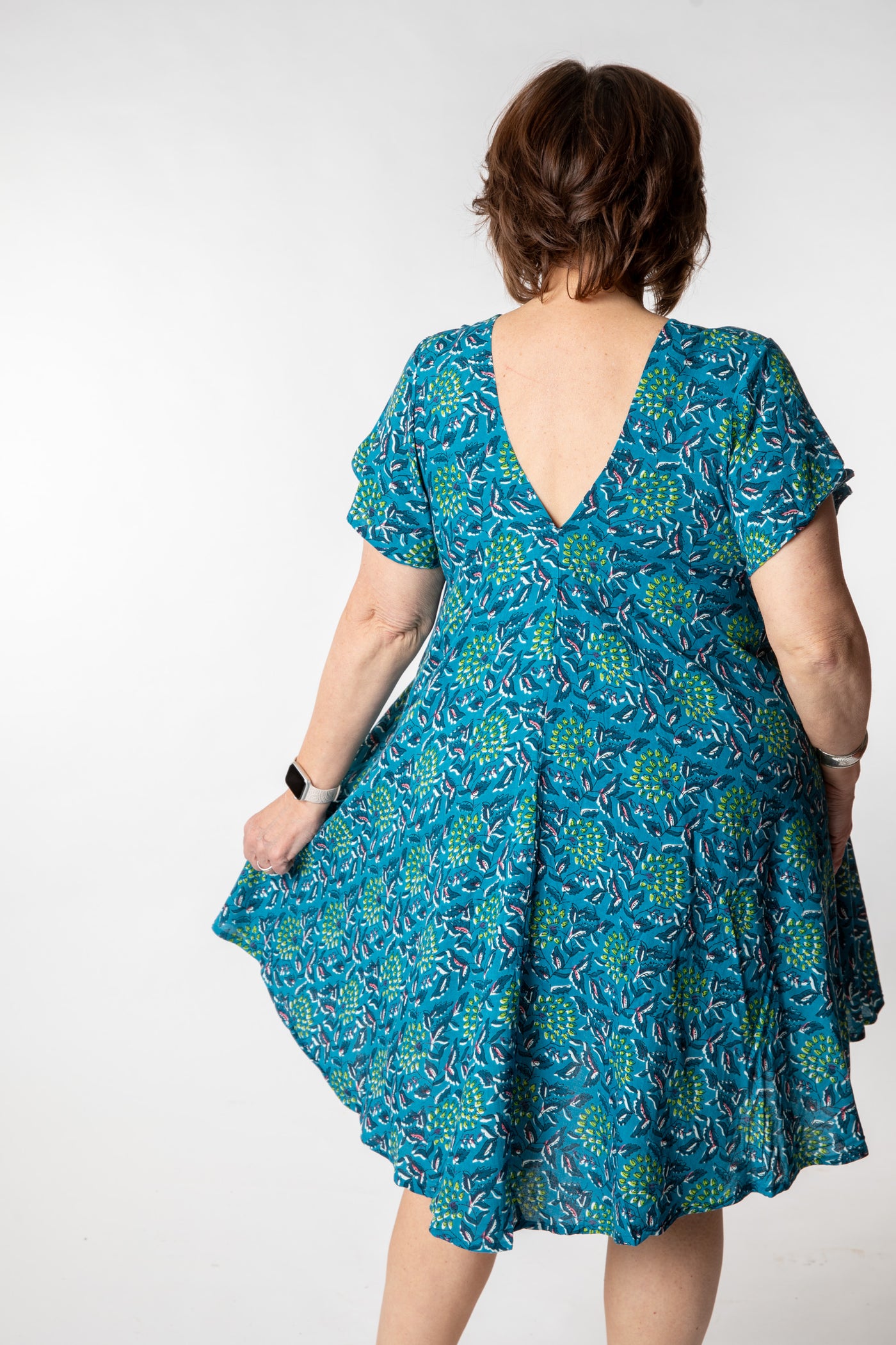 Betty is wearing a babydoll dress teal floral