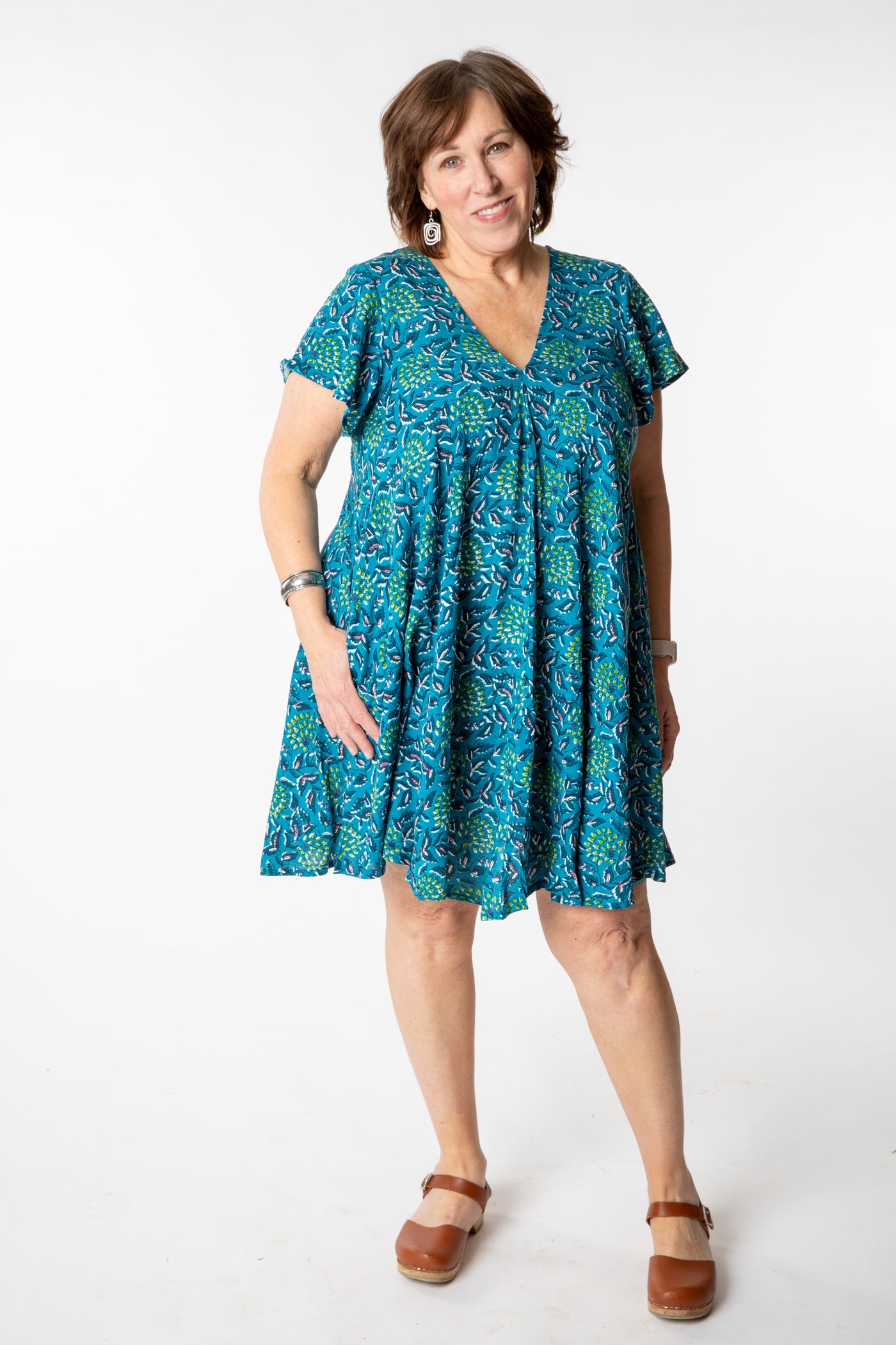 Betty is wearing a babydoll dress teal floral