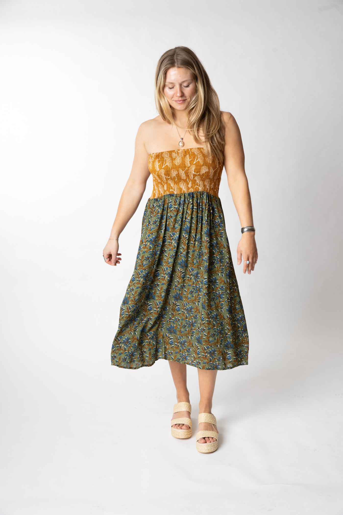 Sophie is wearing a convertible dress in sage floral