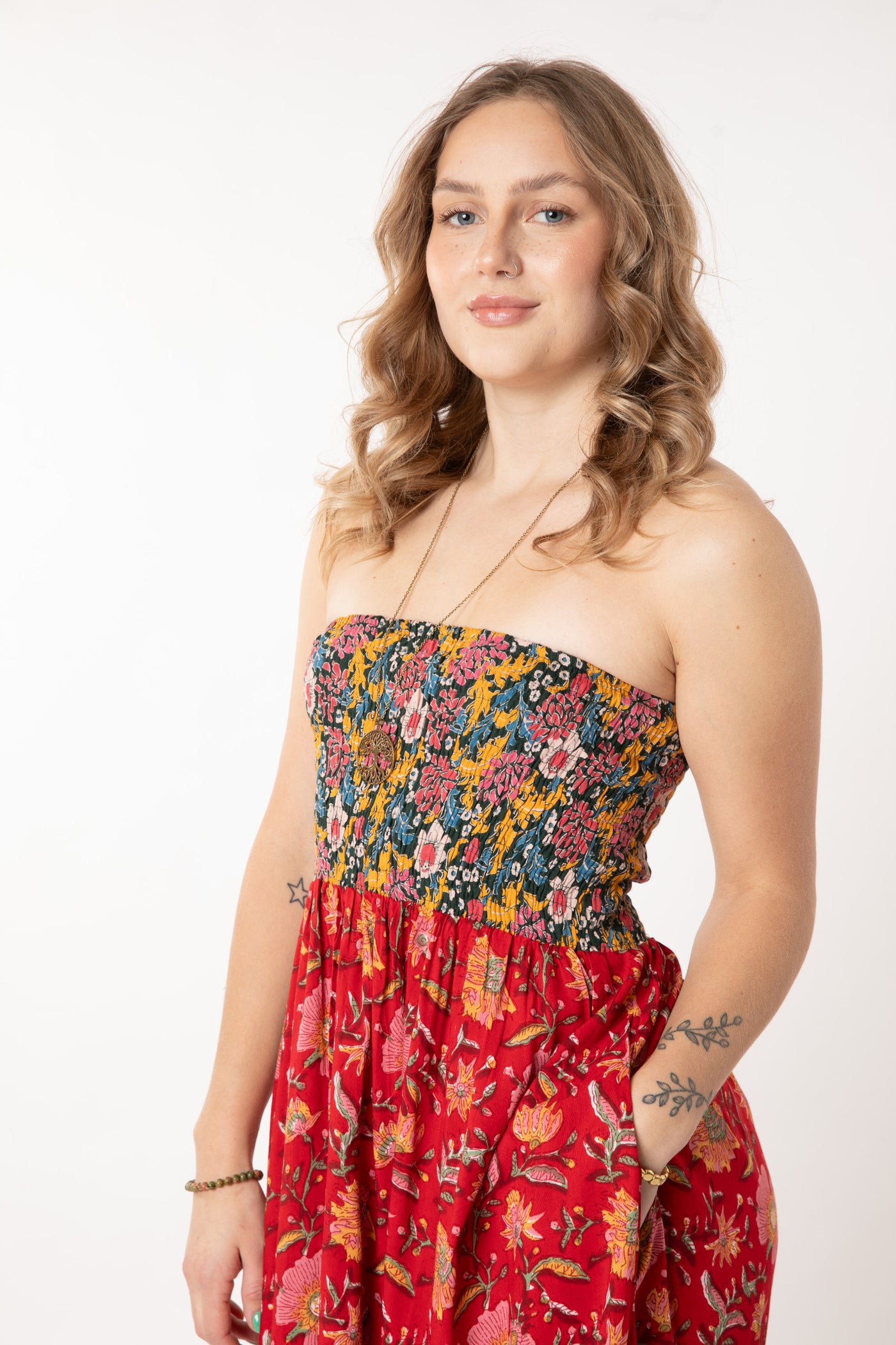 Jacalyn is wearing a convertible dress in scarlet floral