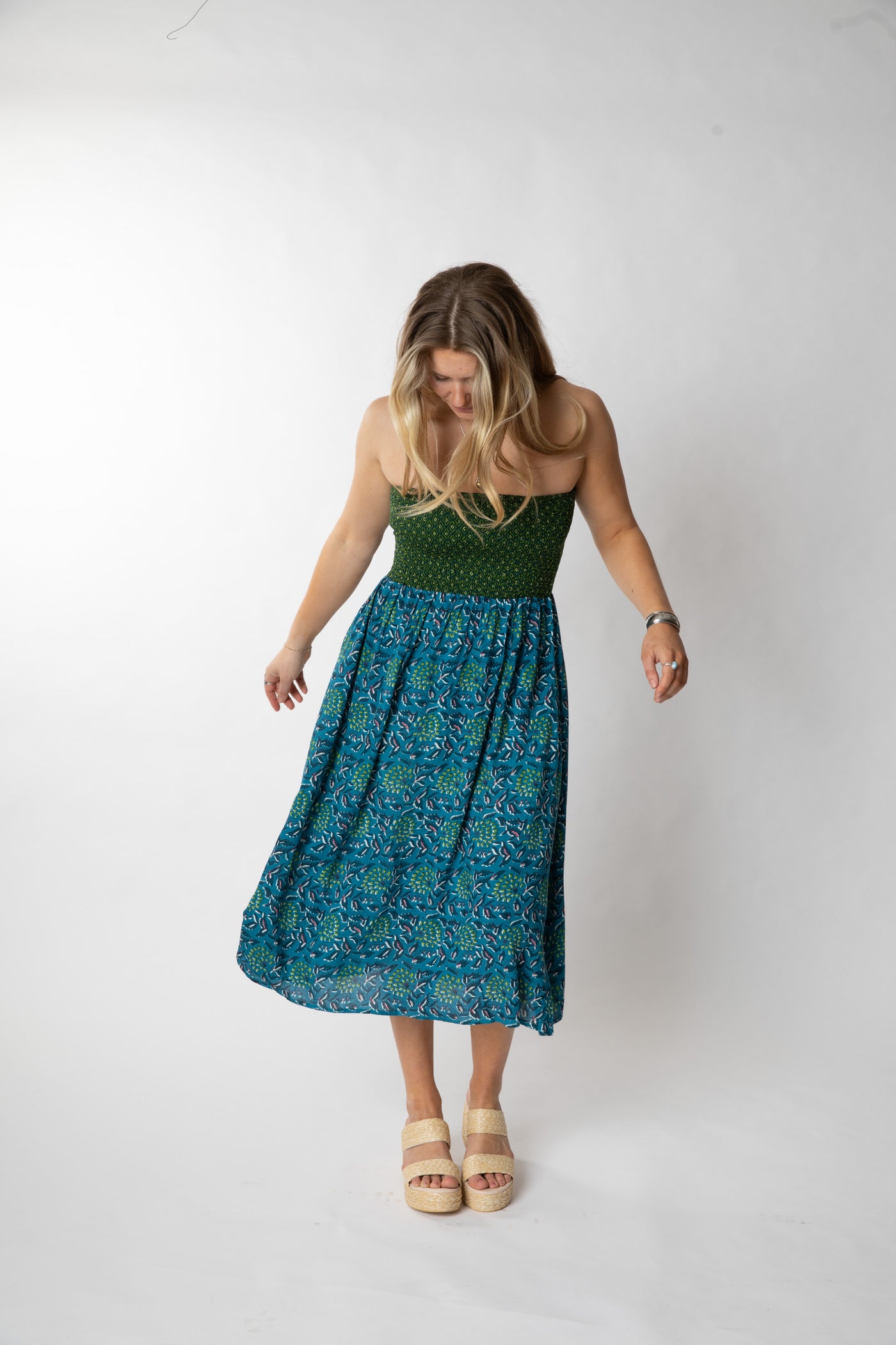 Sophie is wearing a convertible dress in teal floral