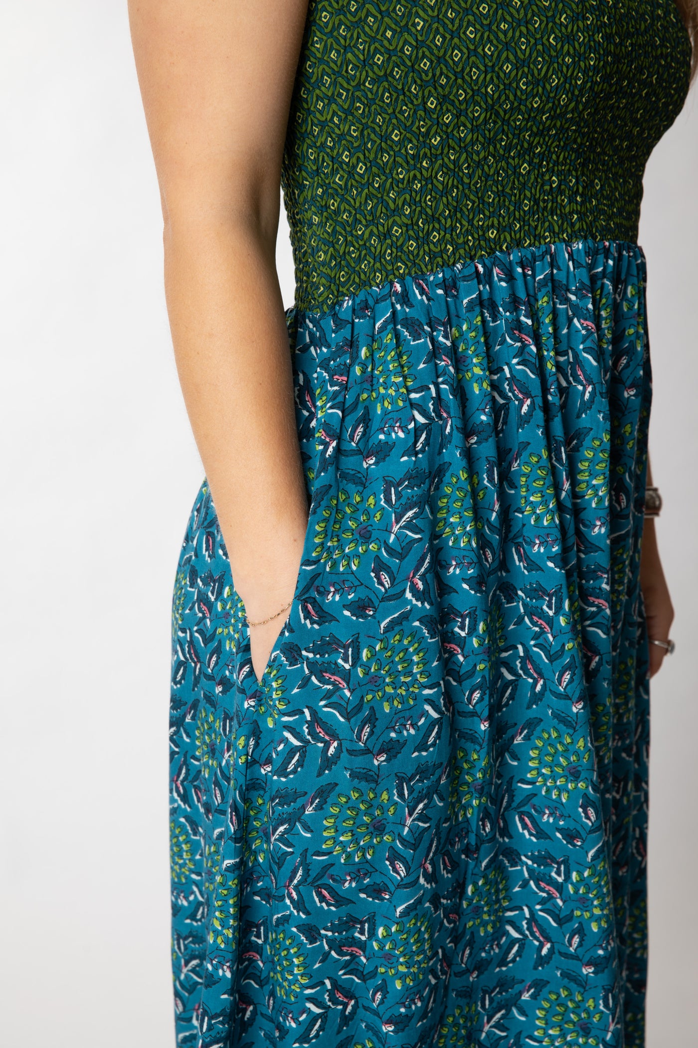 Sophie is wearing a convertible dress in teal floral