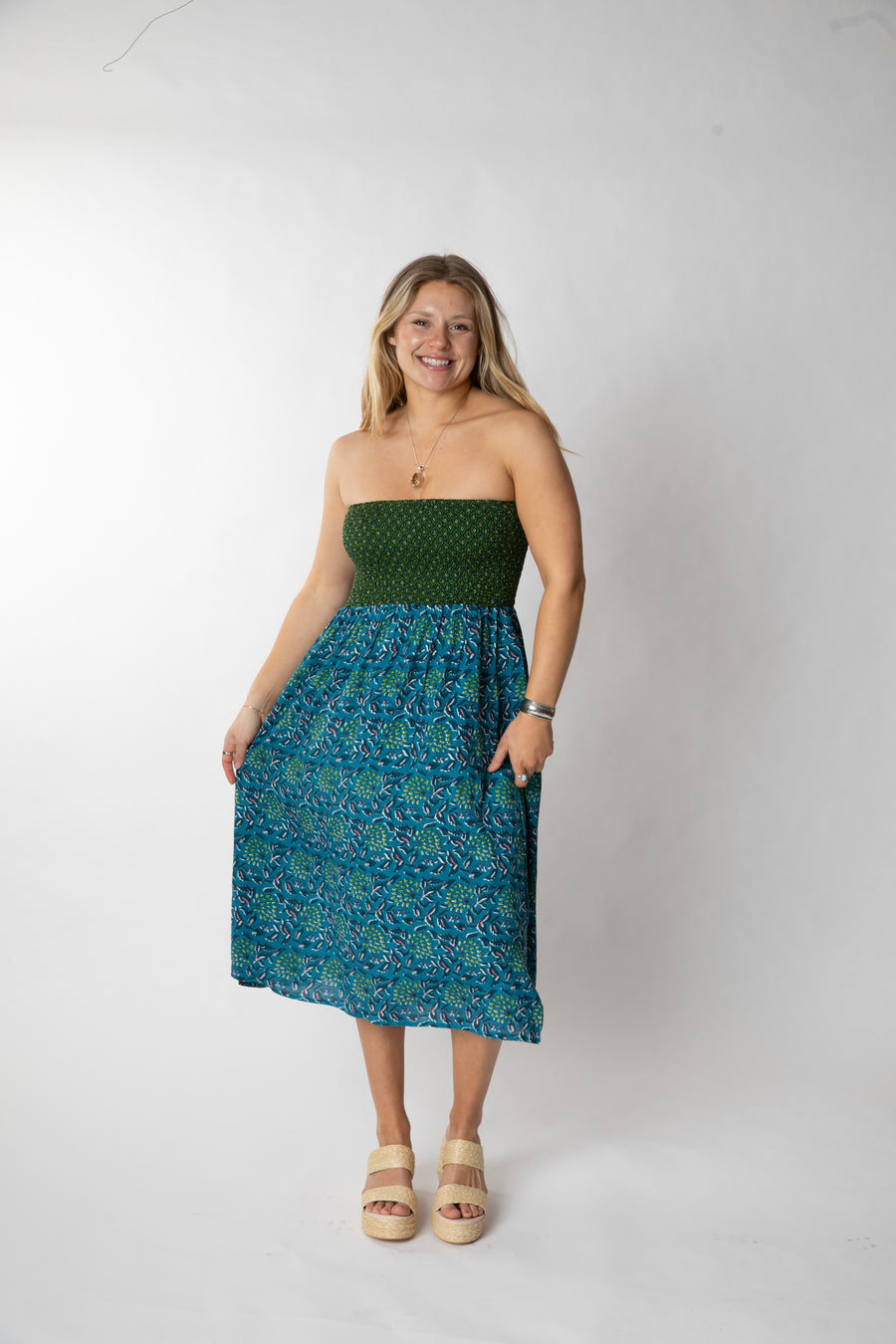 Sophie is wearing a convertible dress in teal floral