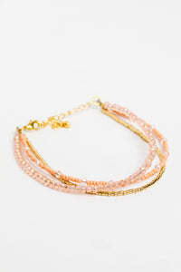adjustable dainty beaded bracelet in pink on white background