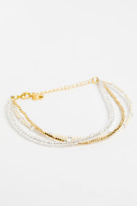 adjustable dainty beaded bracelet in white on white background