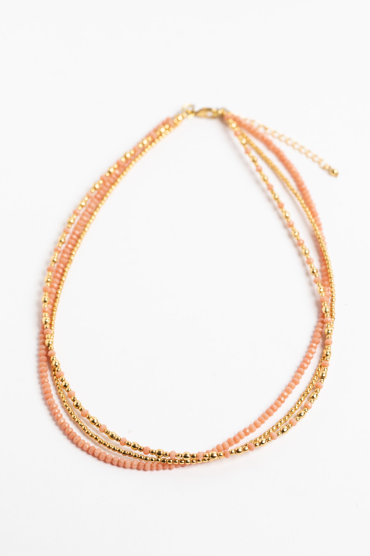 layered beaded necklace in pink on white background