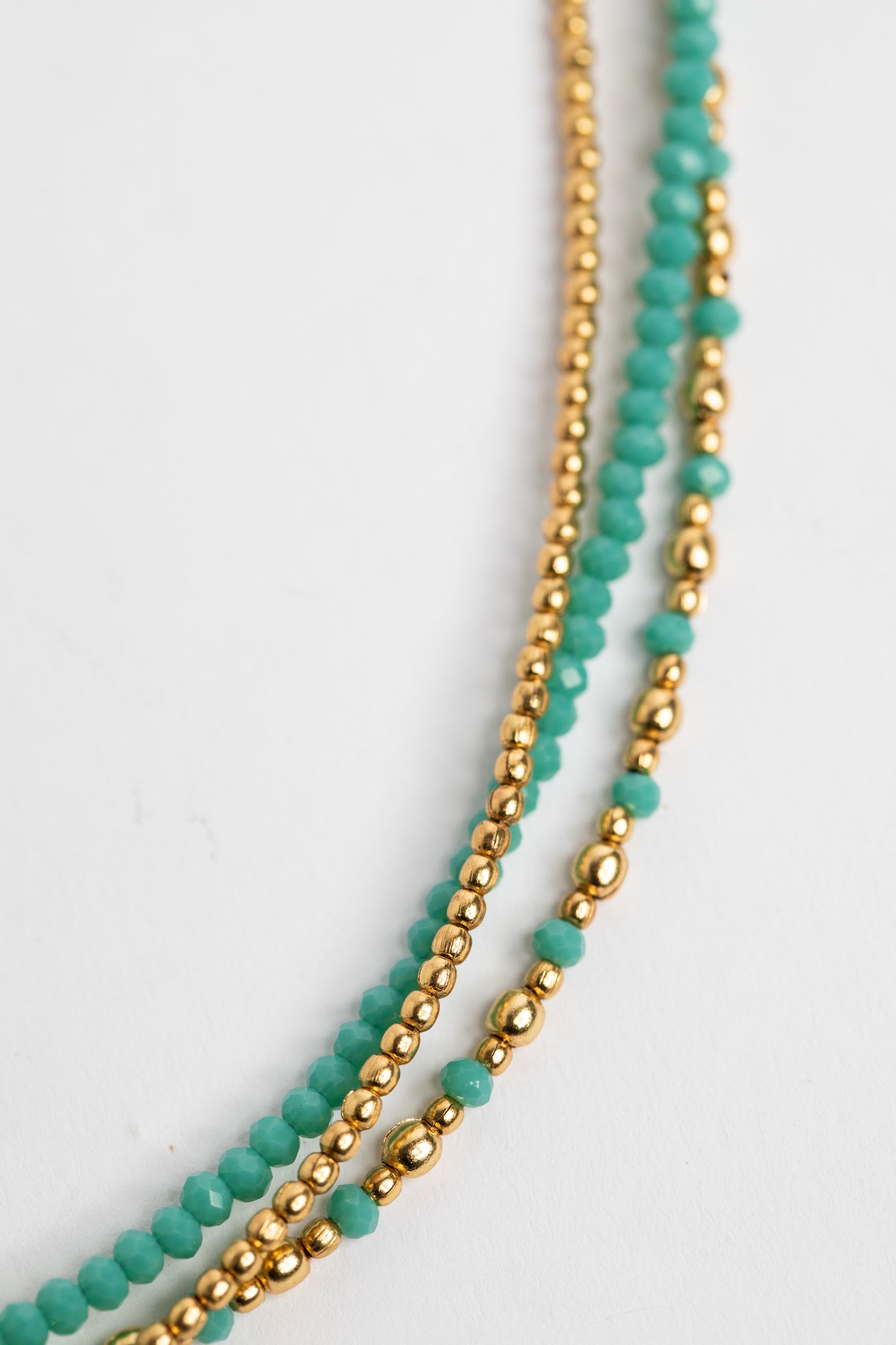 layered beaded necklace in tuquoise on white background