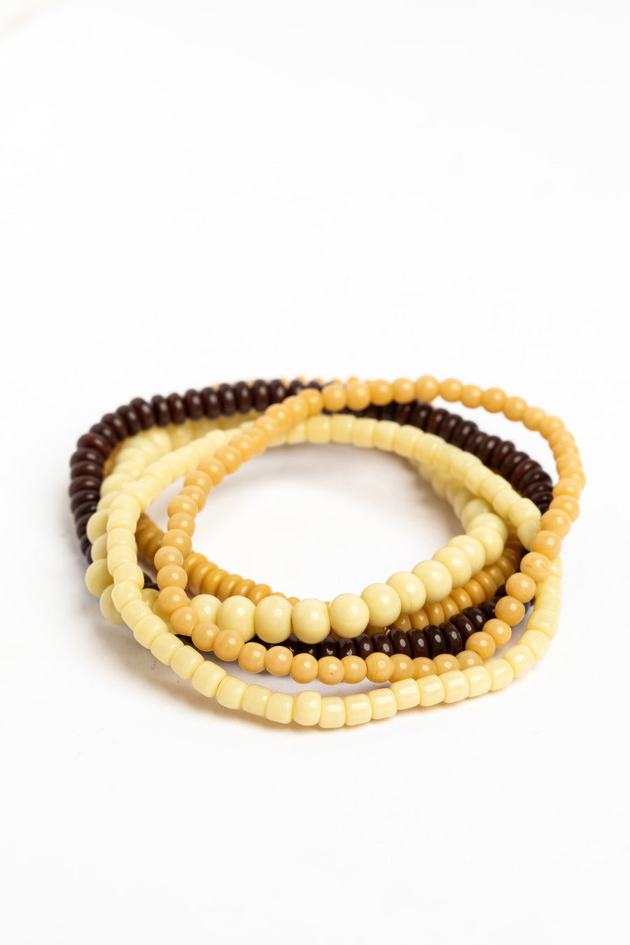 stackable beaded bracelets in natural on white background
