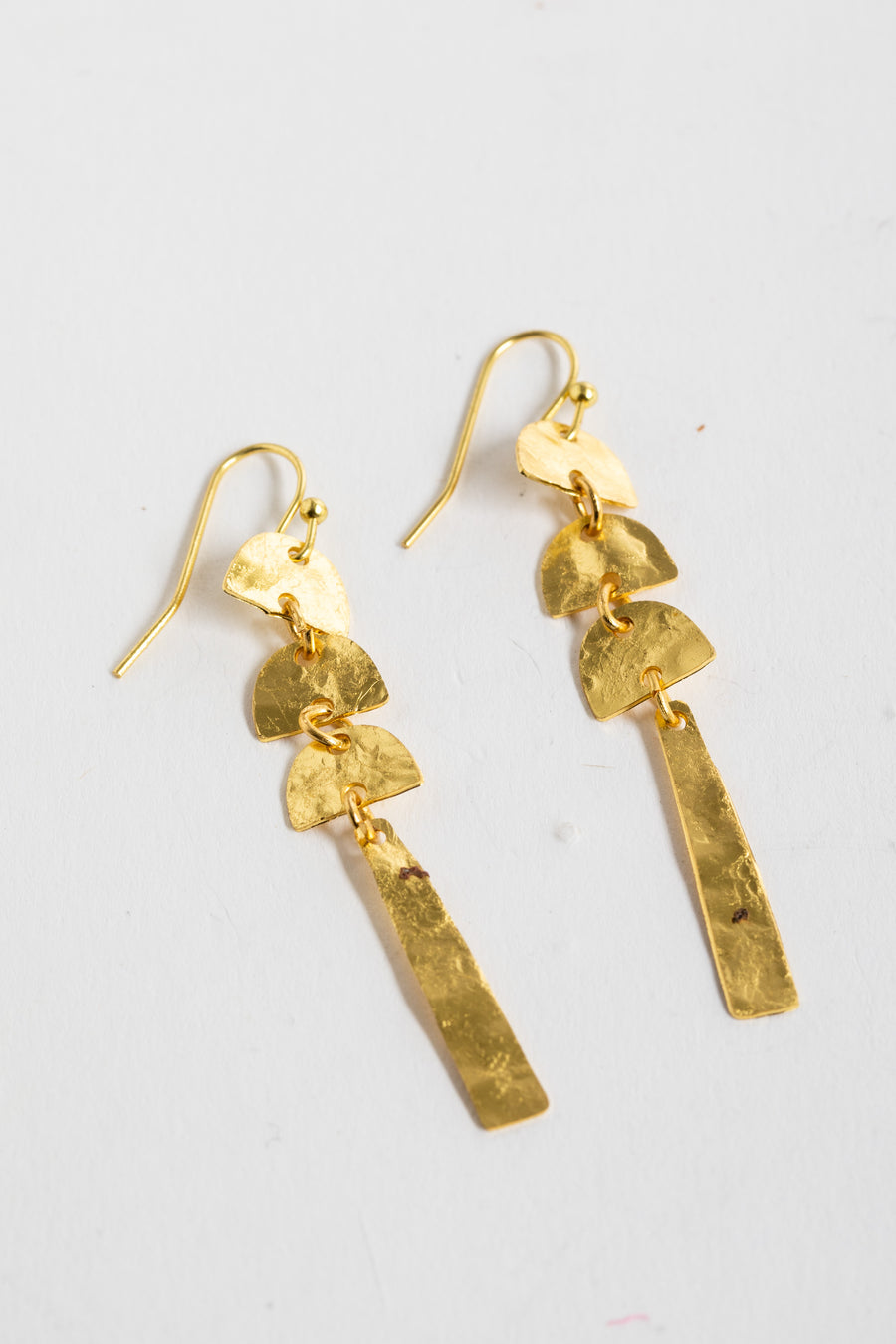 gold boho dangle earrings on white background