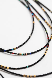 multi strand beaded necklace in black on white background