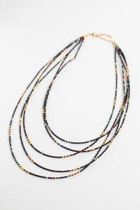 multi strand beaded necklace in black on white background