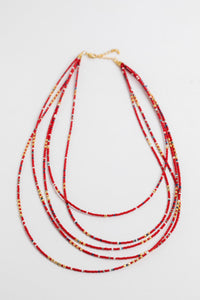 multi strand beaded necklace in red on white background