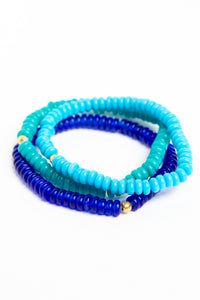 glass bead bracelet set in blue on white background