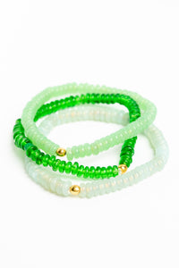 glass bead bracelet set in green on white background