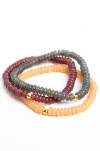 glass bead bracelet set in purple on white background