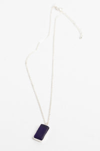 minimalist boho necklace pendant in blue on white background