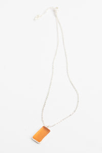 minimalist boho necklace pendant in pink on white background