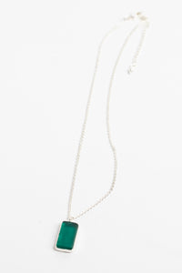 minimalist boho necklace pendant in teal on white background