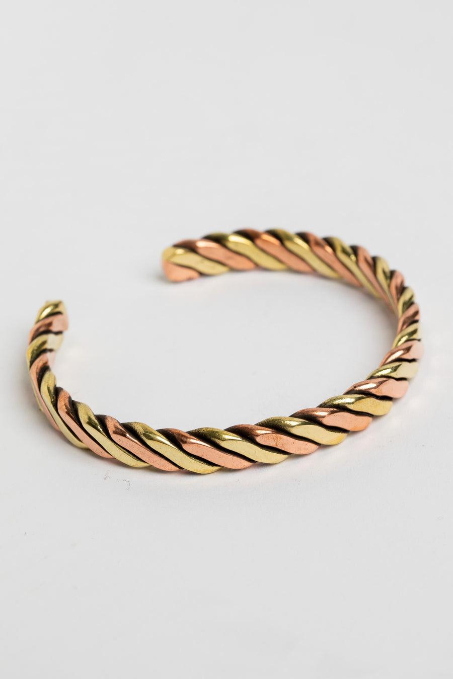 copper cuff bracelet in rope on white background