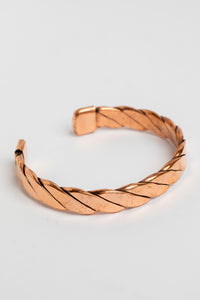 copper cuff bracelet in twist on white background