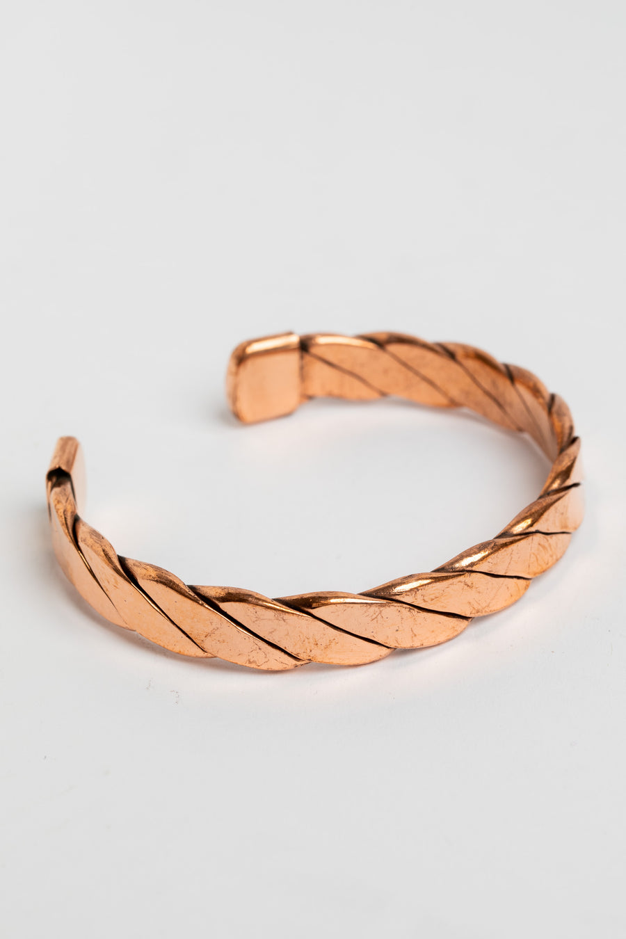 copper cuff bracelet in twist on white background
