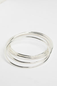 Stackable Metal Bangles in Silver on white background