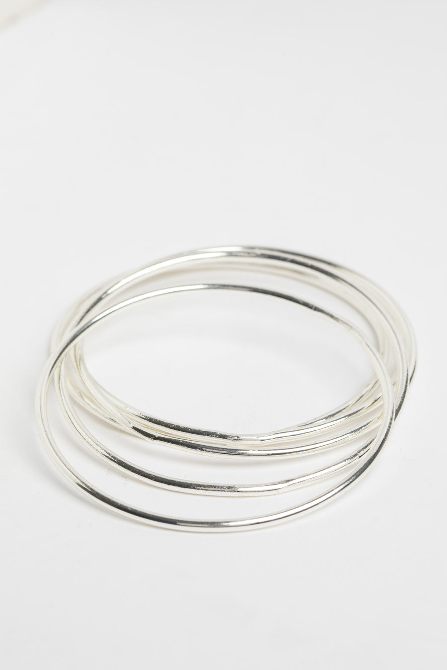 Stackable Metal Bangles in Silver on white background