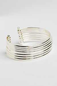 Bold statement wrist cuff in silver on white background