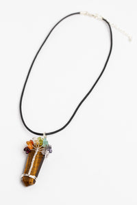 tree of life crystal necklace pendant in tiger eye on white background