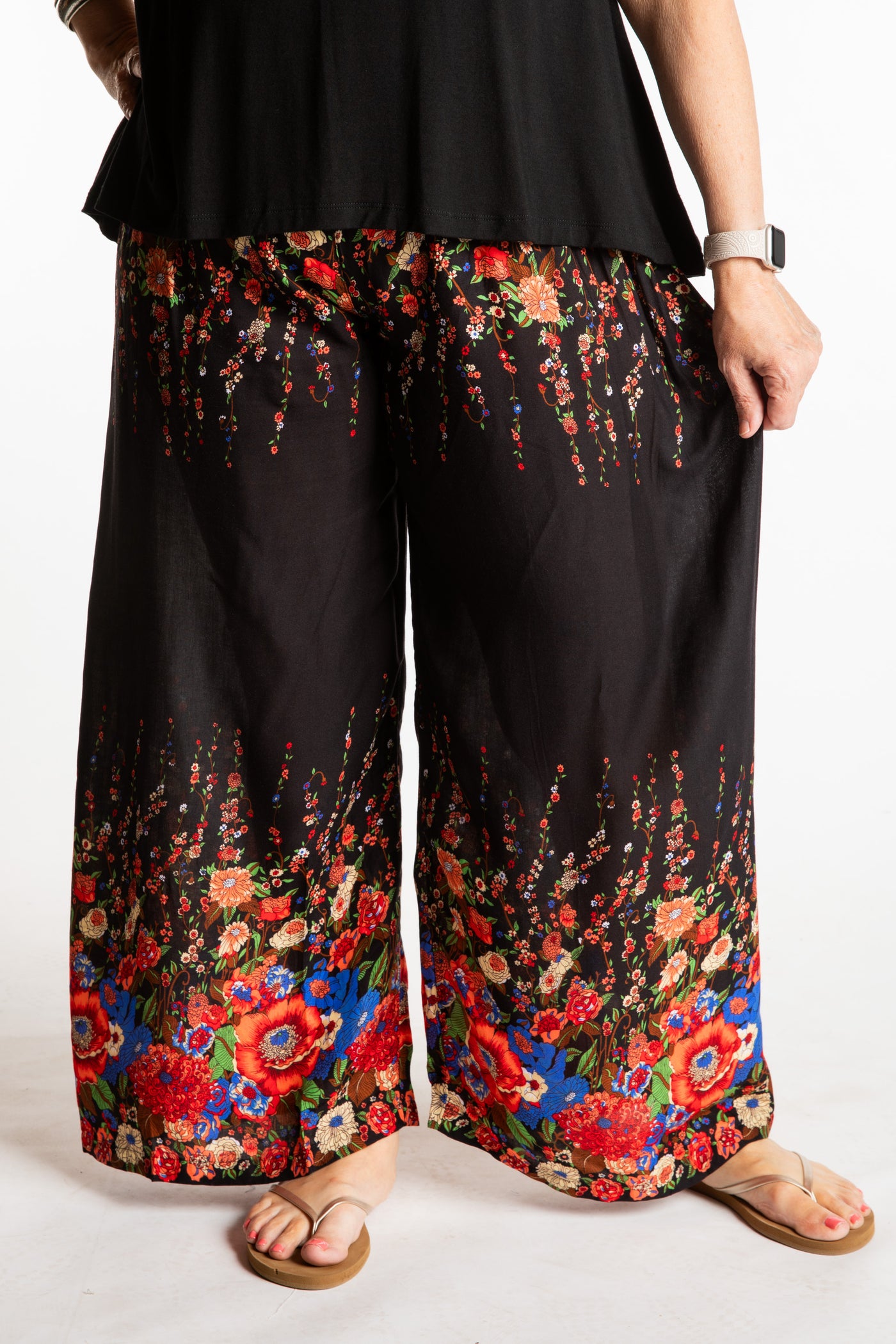 Betty is wearing floral palazzo pants in black