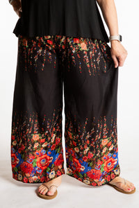Betty is wearing floral palazzo pants in black