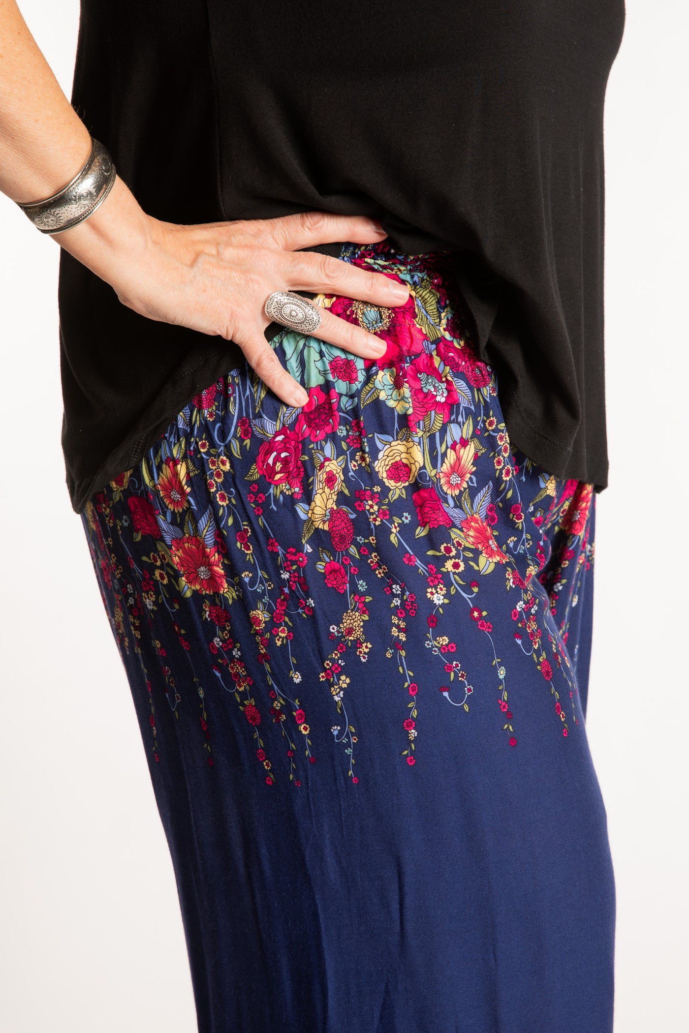 Betty is wearing floral palazzo pants in navy