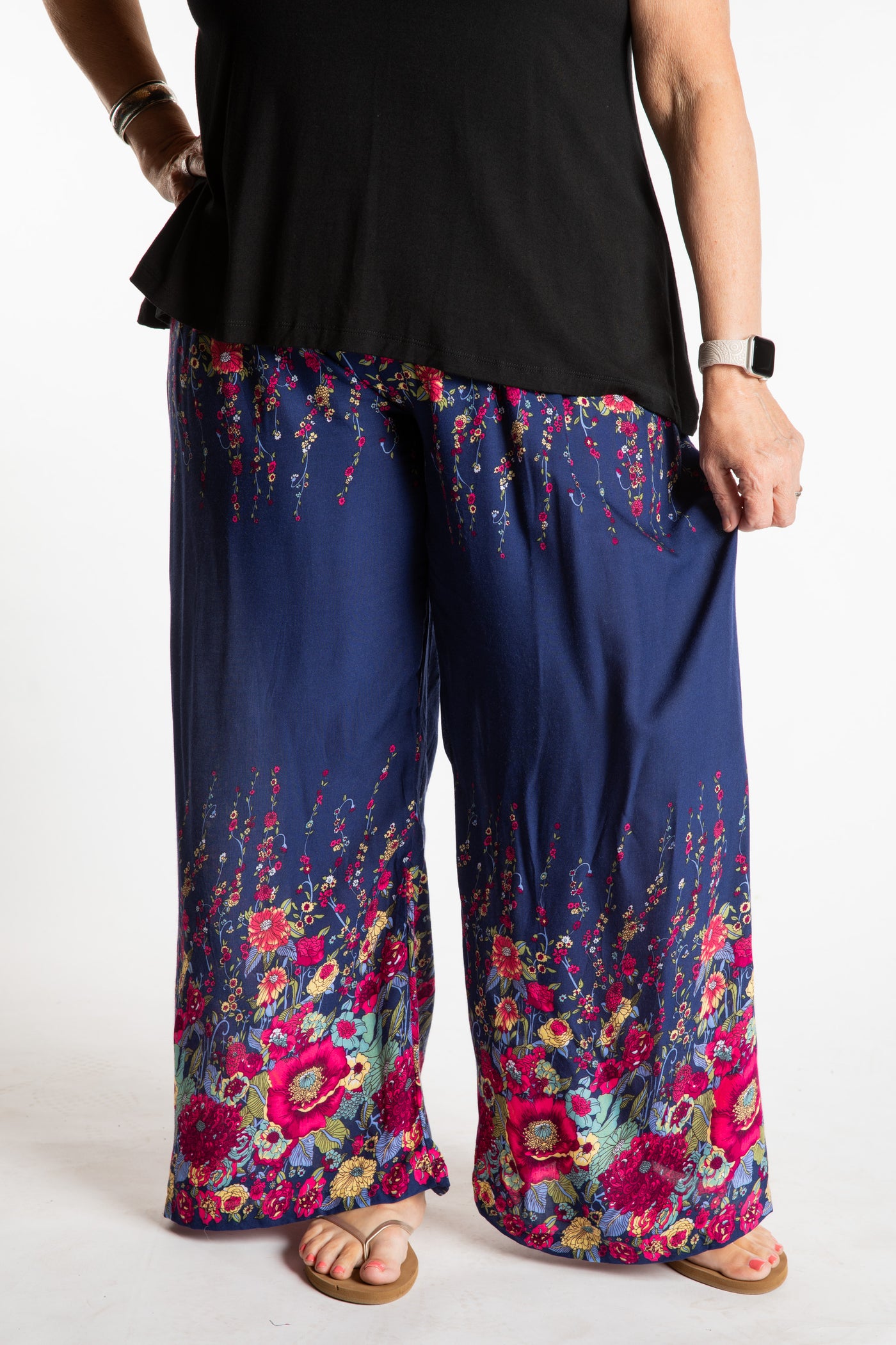 Betty is wearing floral palazzo pants in navy