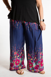 Betty is wearing floral palazzo pants in navy