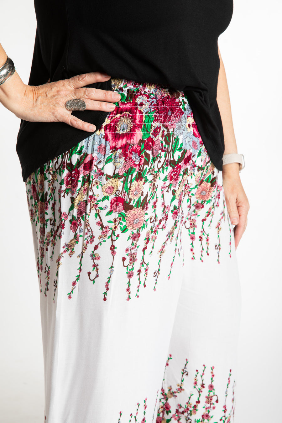Betty is wearing floral palazzo pants in white