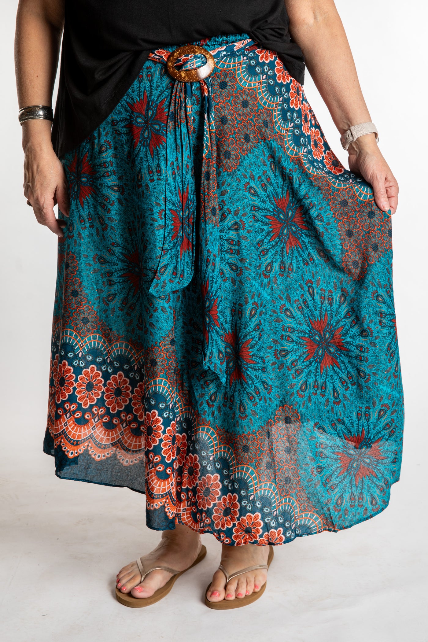 Betty is wearing floral skirt in teal