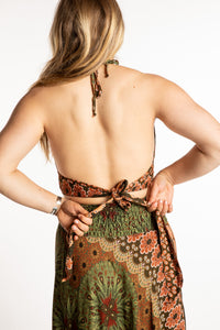 Sophie is wearing a printed halter top in Green and Tan