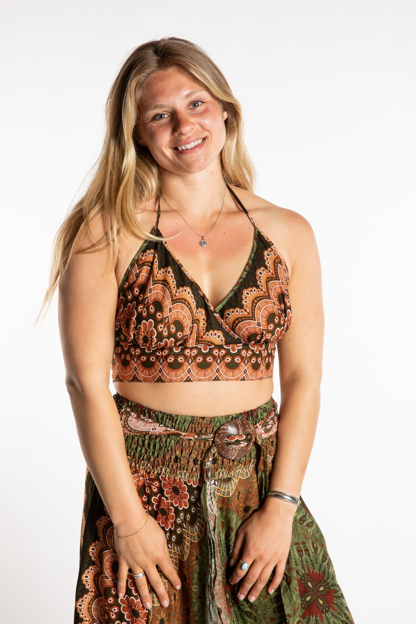 Sophie is wearing a printed halter top in Green and Tan