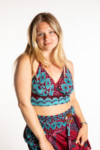 Sophie is wearing a printed halter top in Rose and Turquoise