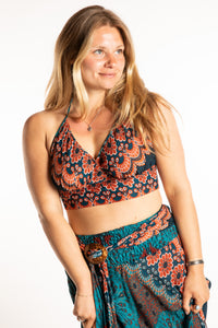 Sophie is wearing a printed halter top in Teal and Orange