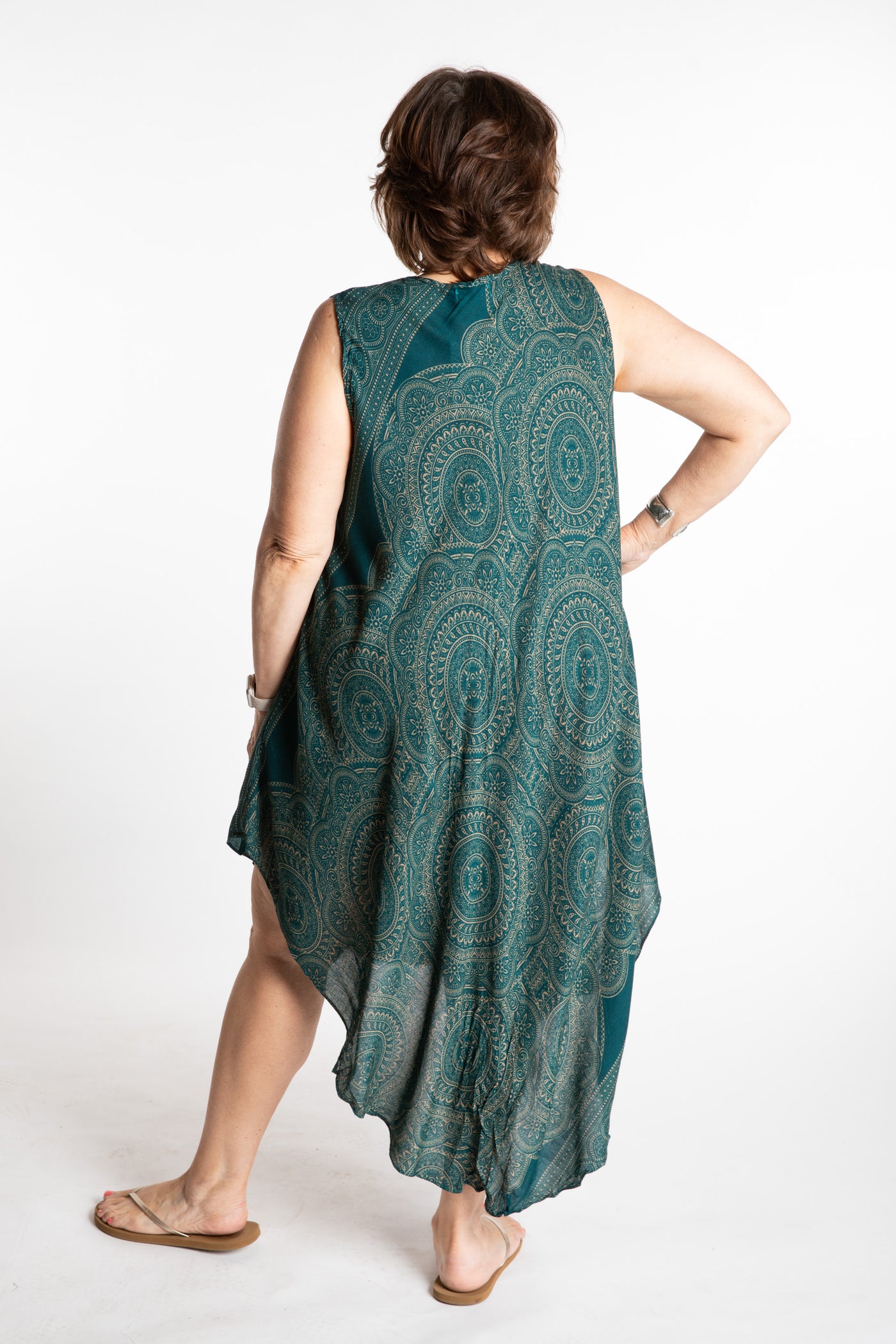 Betty is wearing a flowy dress in Teal