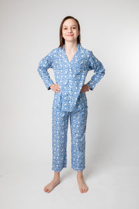 Violet is wearing size 8/9 pajama set in blue poppies