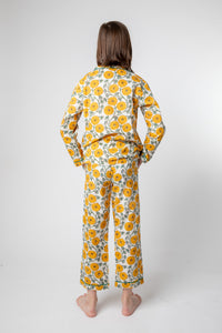 Violet is wearing size 8/9 pajama set in dandelion