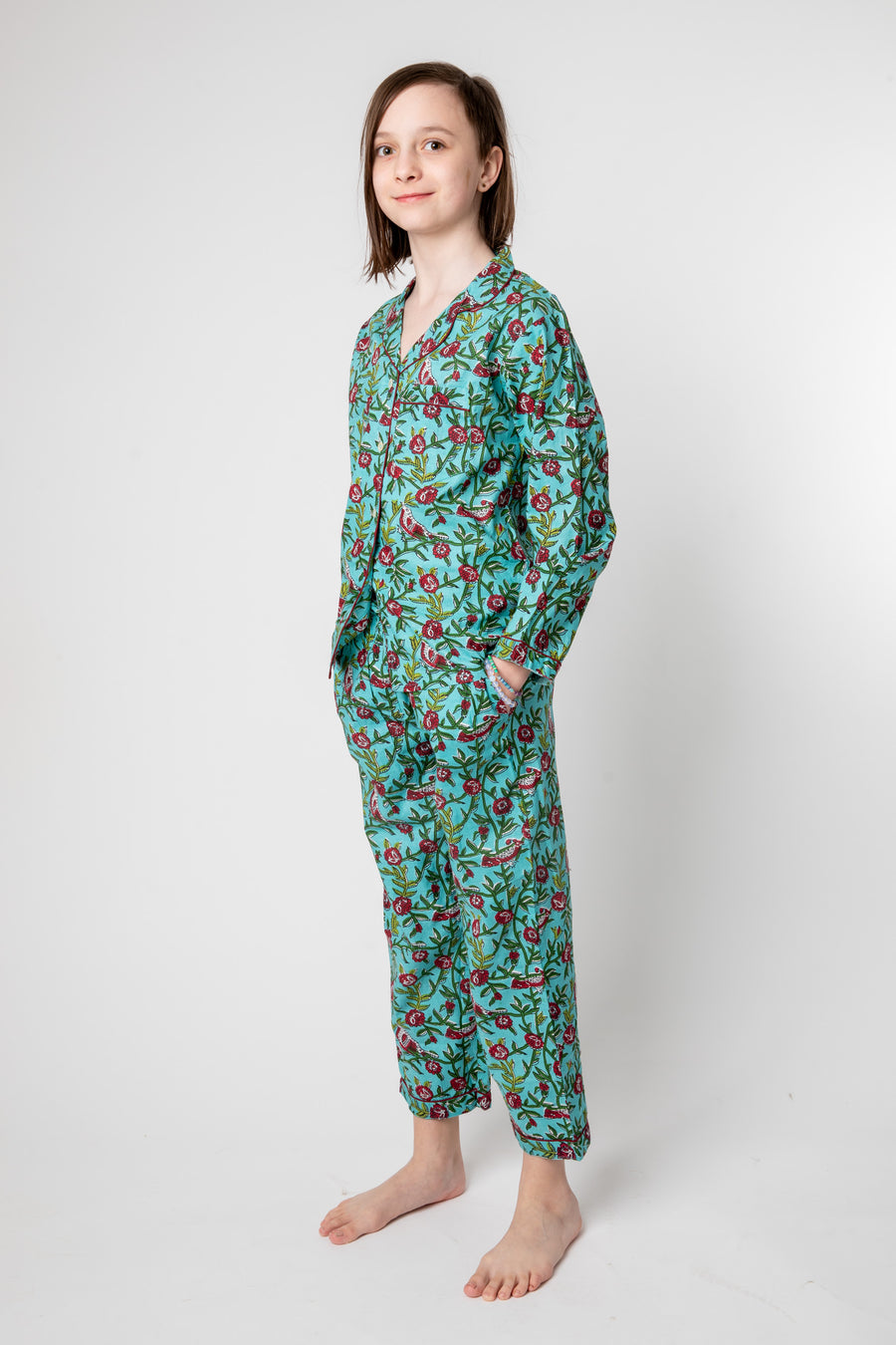 Violet is wearing size 8/9 pajama set in turquoise rosa