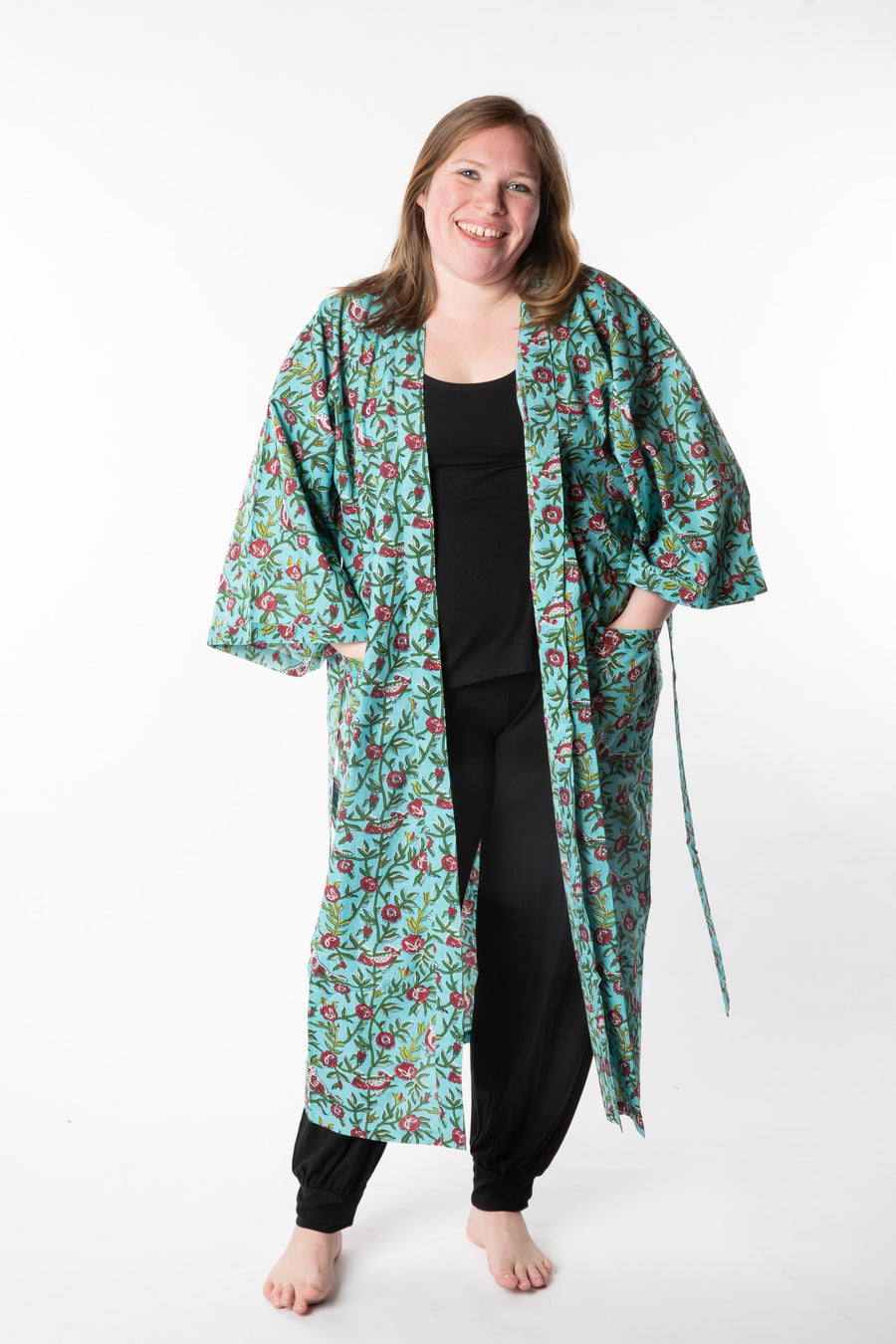 Olivia is wearing a block print robe in turquoise rosa