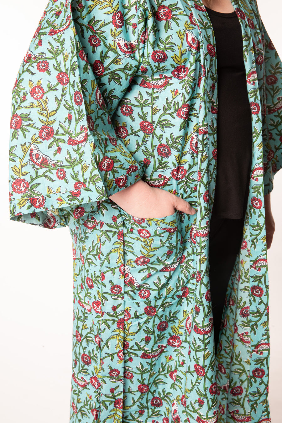 Olivia is wearing a block print robe in turquoise rosa