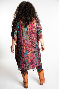 Susan is wearing the assorted one size Pari Poncho