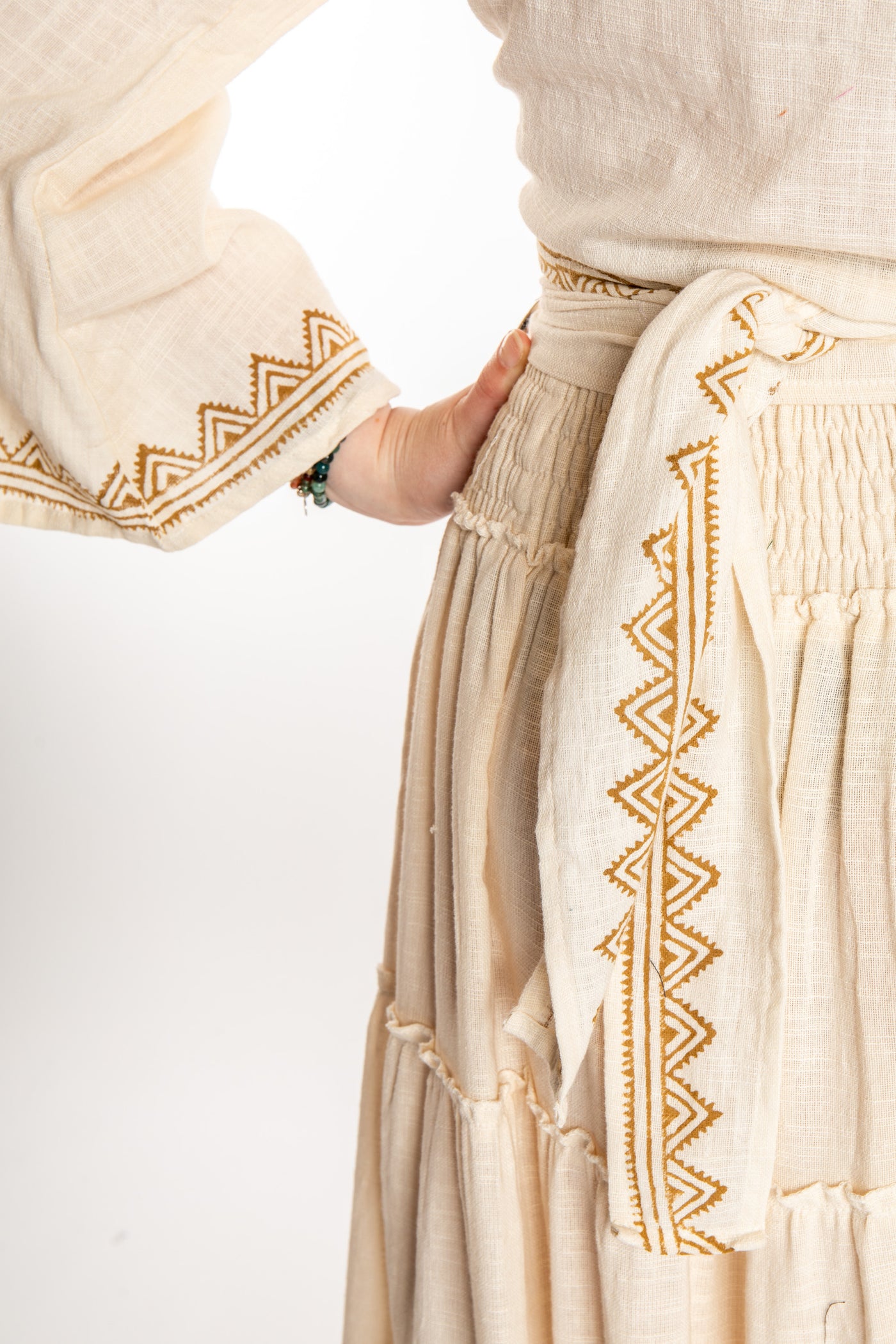 Honora is wearing Bohemian Wrap Top in Ivory